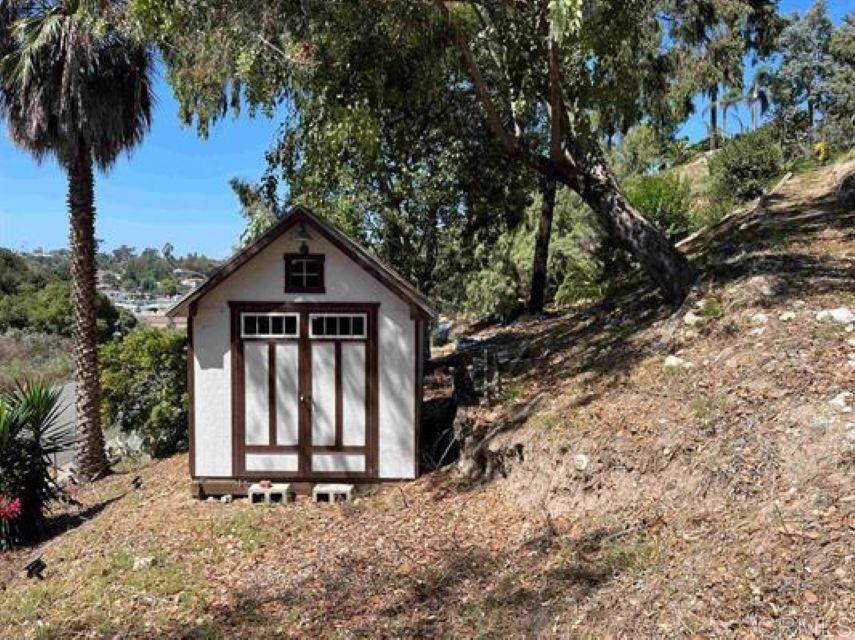 2277 Dunstan Street Oceanside, CA 92054 - Photo 33 of 36 a view of barn with a small yard and large trees
