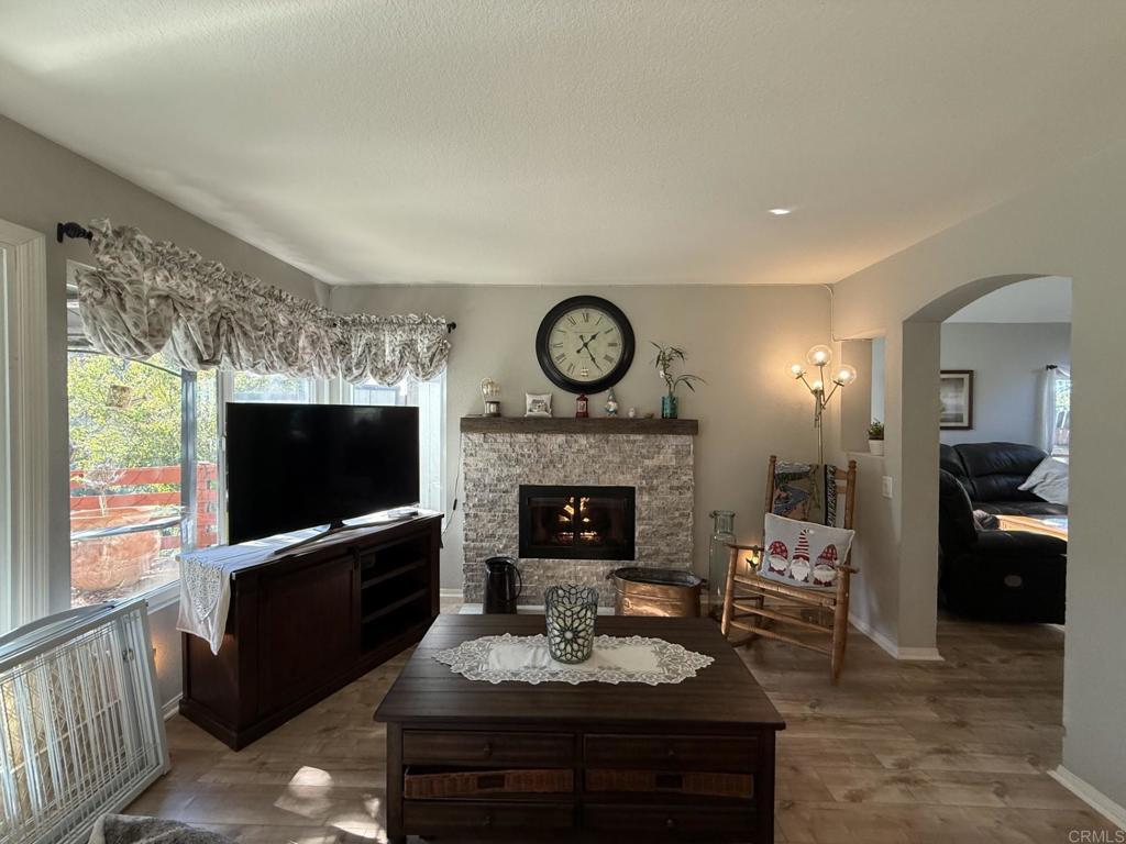 2277 Dunstan Street Oceanside, CA 92054 - Photo 6 of 36 a living room with furniture a flat screen tv and a fireplace