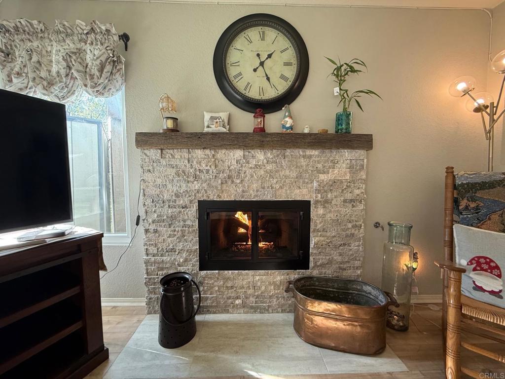 2277 Dunstan Street Oceanside, CA 92054 - Photo 8 of 36 a living room with a fireplace a clock and a fireplace