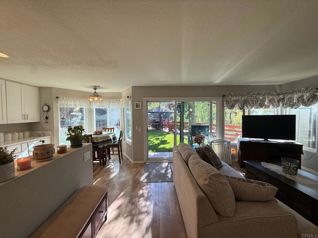 2277 Dunstan Street Oceanside, CA 92054 - Photo 9 of 36 a living room with fireplace furniture and a flat screen tv