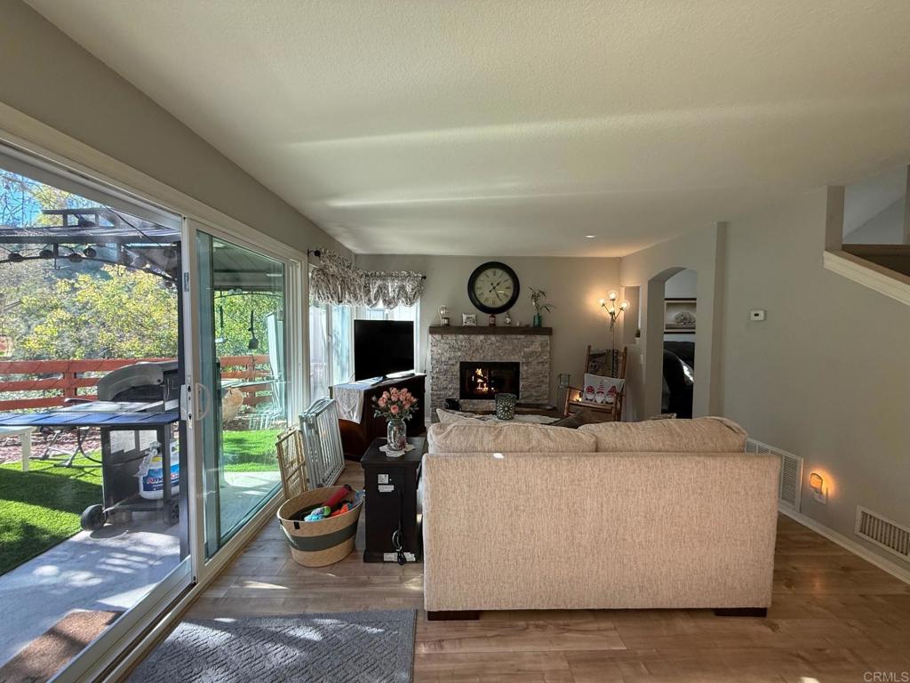 2277 Dunstan Street Oceanside, CA 92054 - Photo 10 of 36 a living room with fireplace furniture and a large window