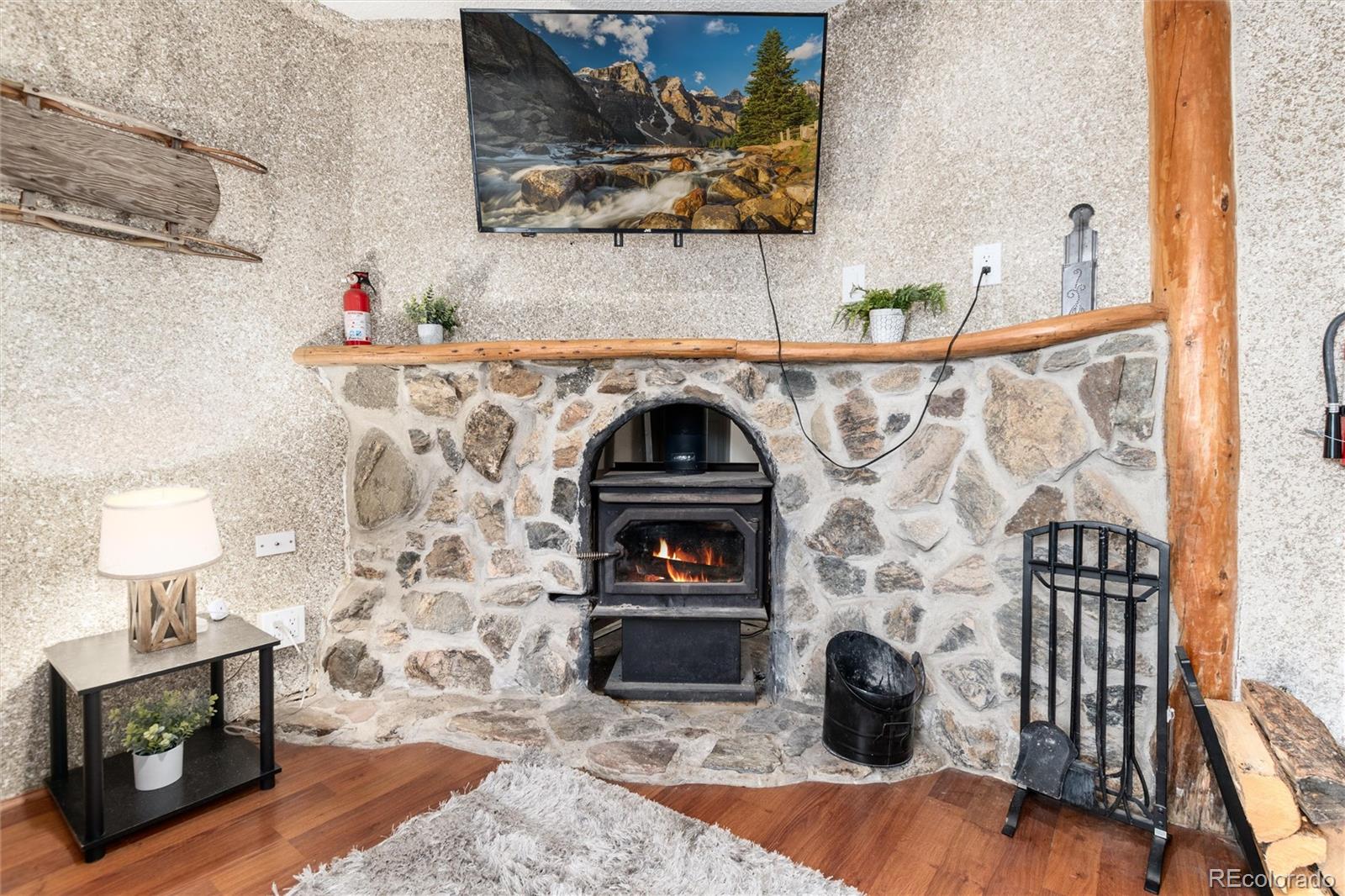 159 Lake Road Idaho Springs, CO 80452 - Photo 24 of 45 a view of wooden floor in livingroom with fireplace