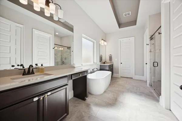 a spacious bathroom with a granite countertop sink toilet and shower