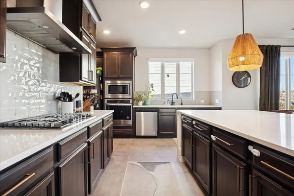 a kitchen with a sink appliances and cabinets