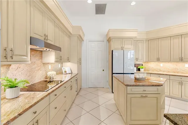 a kitchen with granite countertop a sink stainless steel appliances and cabinets