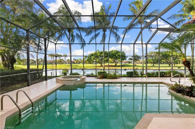 a view of a swimming pool with a couches and chairs