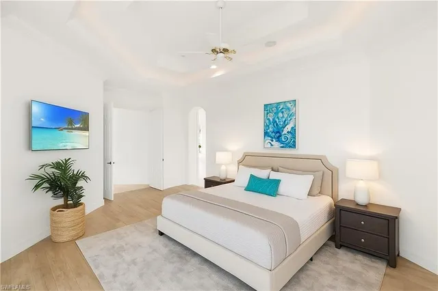 a bedroom with a bed and a potted plant