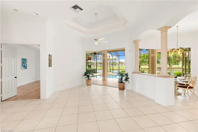 a living room with furniture and large windows