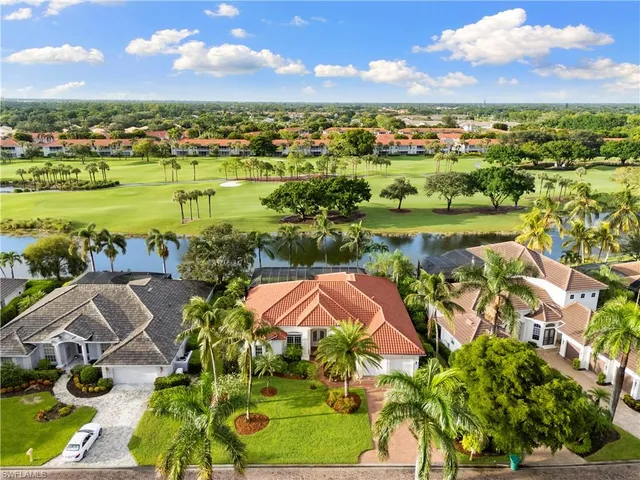 an aerial view of residential houses with outdoor space and river