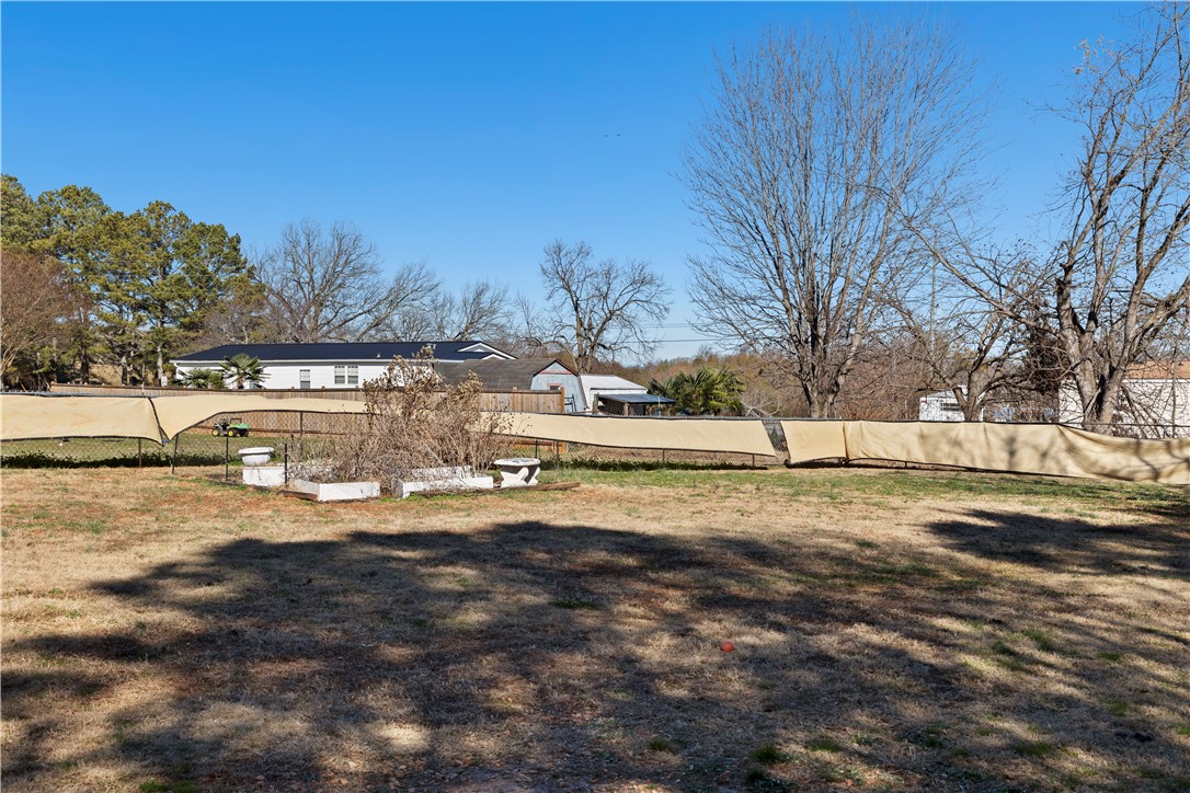 811 Pine Grove Road Seneca, SC 29678 - Photo 17 of 20 This expansive backyard offers a tranquil outdoor escape with a large grassy area.