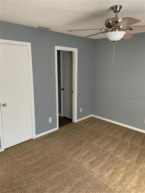 1055 South Hiawassee Road, Unit 2012 Orlando, FL 32835 - Photo 12 of 19 a view of an empty room with a chandelier fan