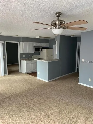 a view of a kitchen with a sink and a kitchen view
