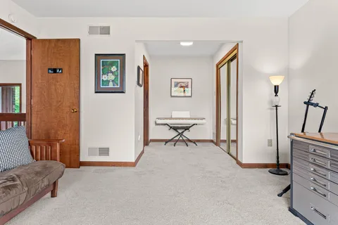 a room with gym equipment and wooden floor