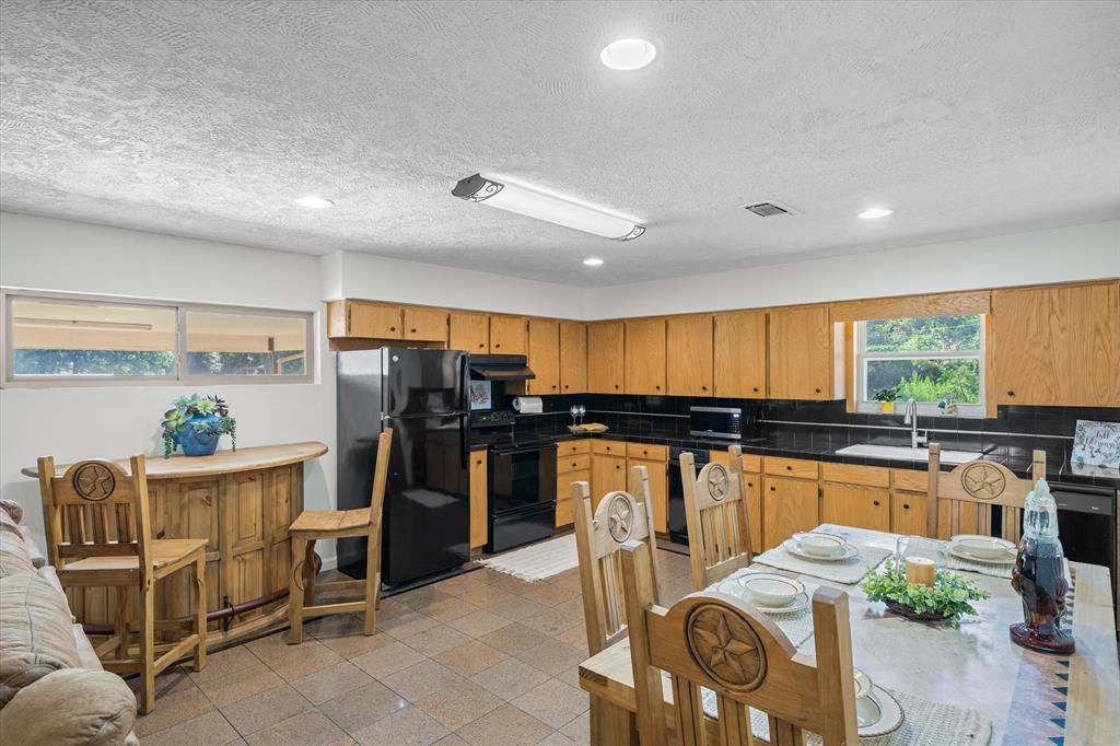 913 Doe Run Road Tool, TX 75143 - Photo 12 of 38 The open kitchen allows for flexibility to meet buyer needs. Add an island, game table, or even extend cabinetry.