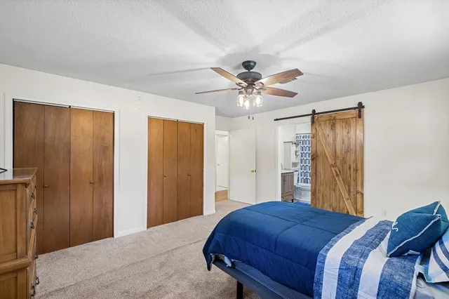 a bedroom with a large bed and a chandelier