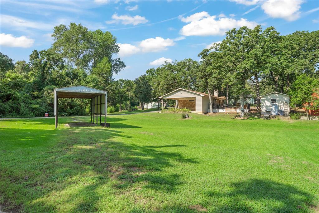 913 Doe Run Road Tool, TX 75143 - Photo 32 of 38 The house sits up on the hill to allow for a great breeze across the patio. Host a friends and family football game on those cool fall and winter holidays!