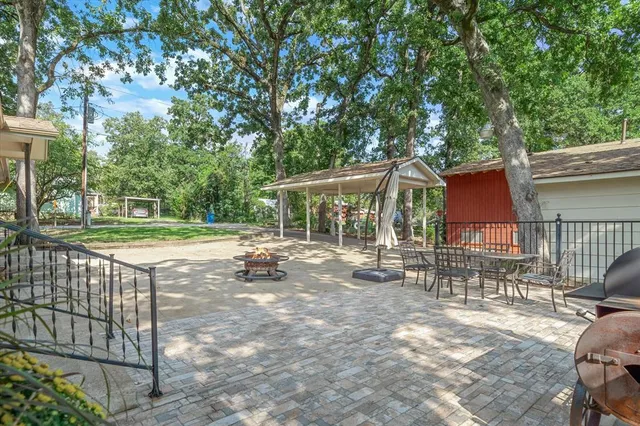 a view of a patio with a table and chairs and potted plants