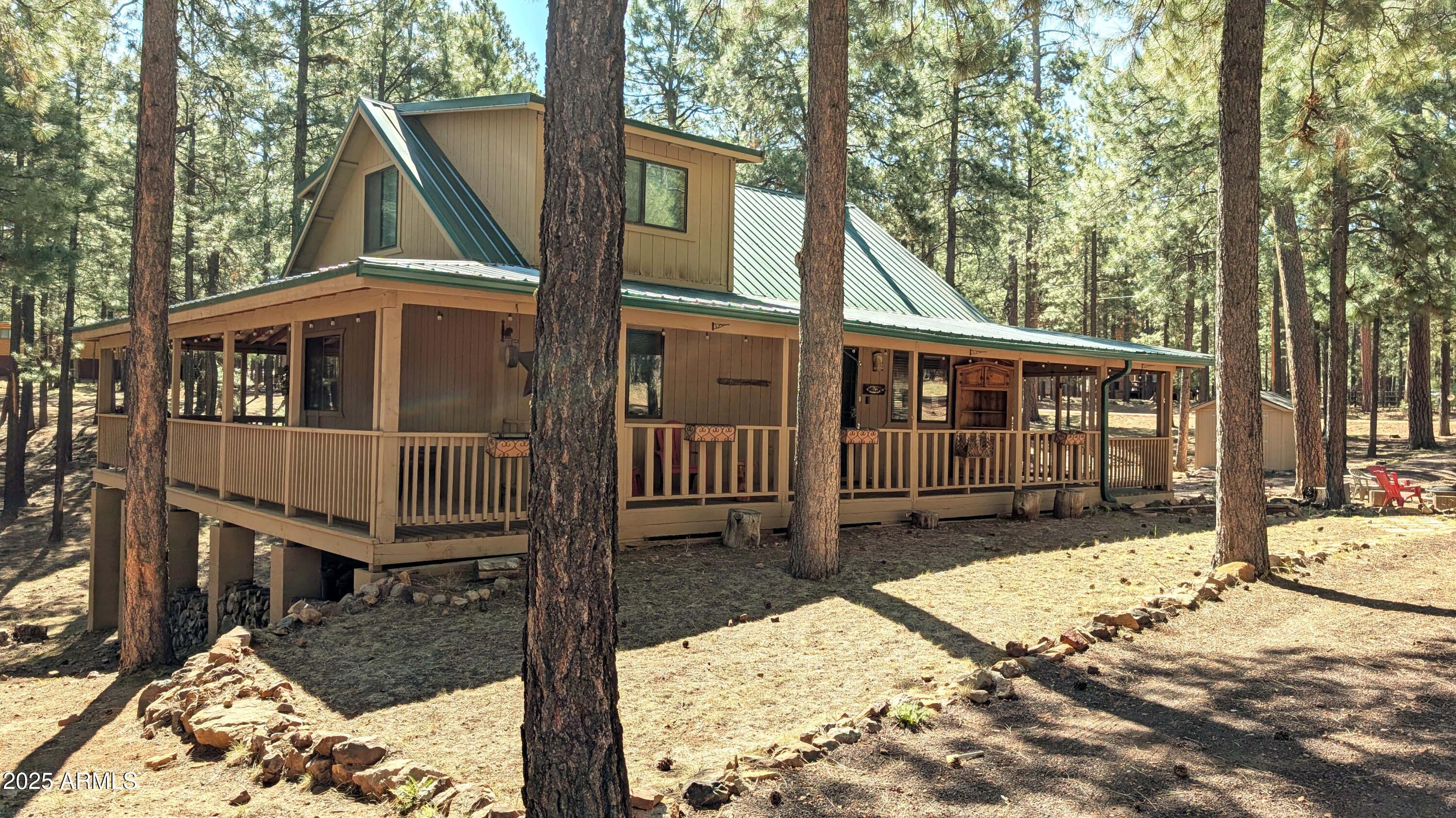 a view of a house with a wooden bench in a yard