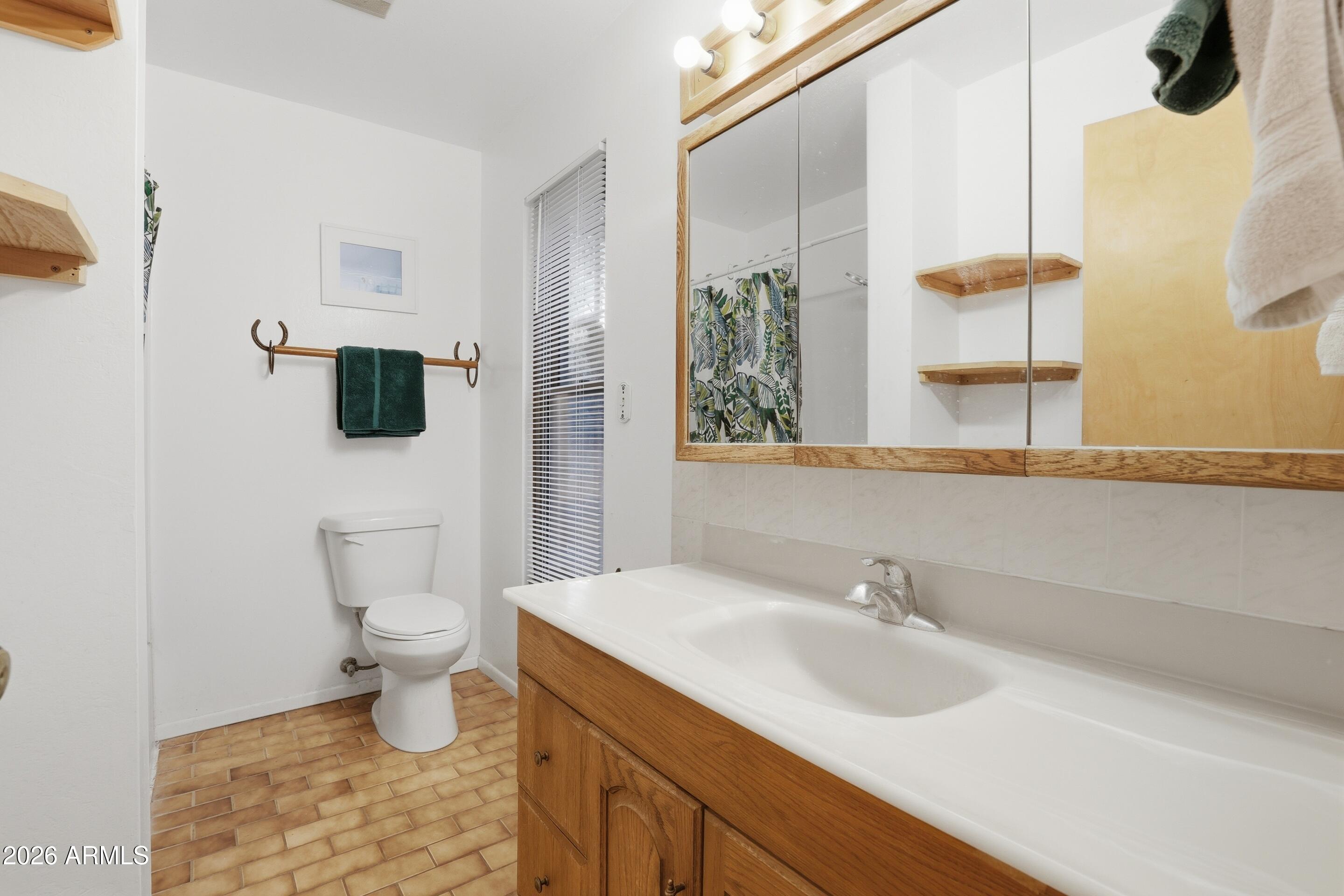 8135 West Gibson Ranch Road Payson, AZ 85541 - Photo 12 of 43 a bathroom with a sink toilet a mirror and shower