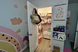 a view of a livingroom with wooden floor and a ceiling fan