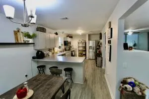 a kitchen with sink refrigerator and microwave