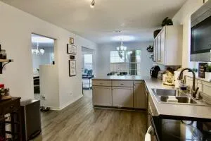 a kitchen with a sink stainless steel appliances and cabinets