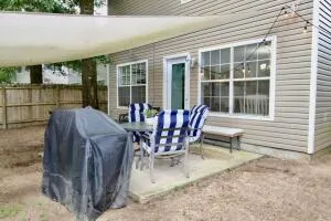 a view of backyard with table and chairs and potted plants