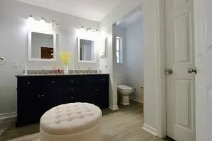 a bathroom with a granite countertop toilet sink and mirror