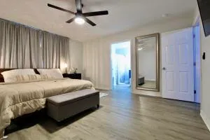 a spacious bedroom with a bed and wooden floor