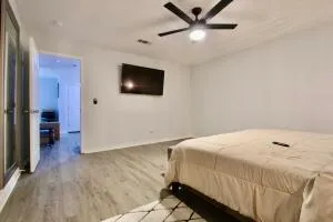 a bedroom with a bed and a flat screen tv