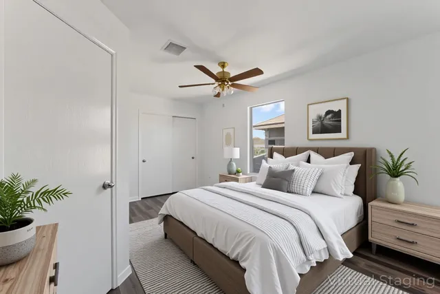 a bedroom with bed and a potted plant