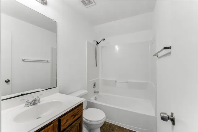 a bathroom with a sink mirror toilet and bathtub