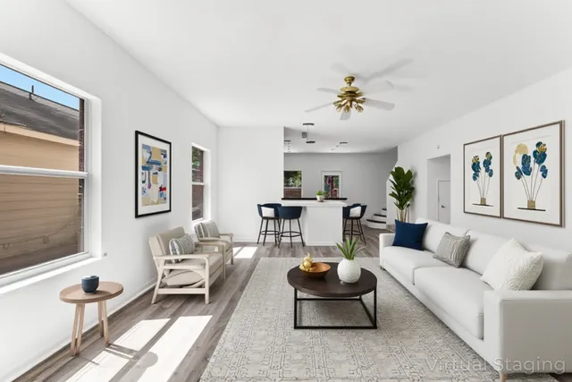 a living room with furniture a rug and a window