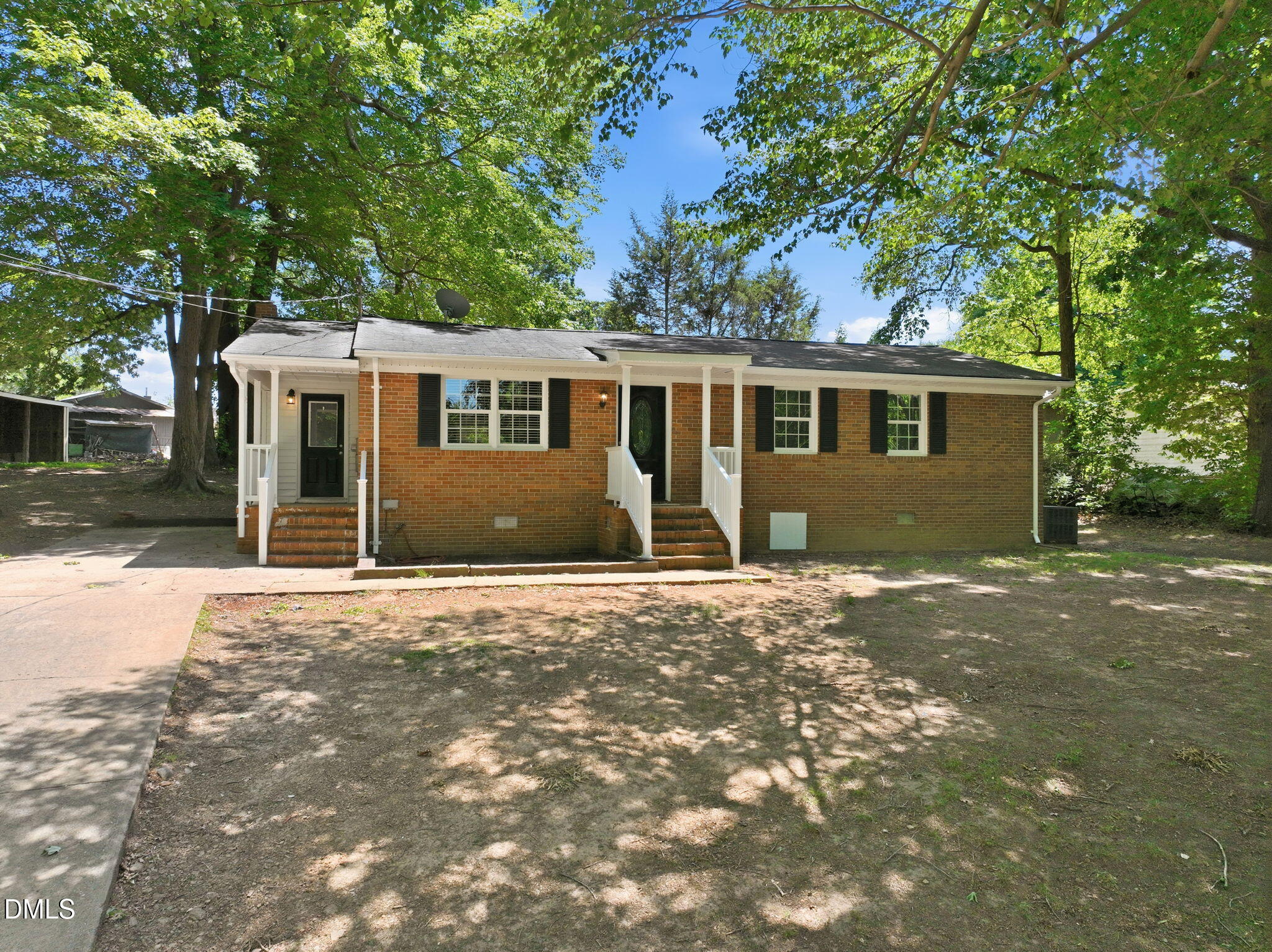 265 Shady Hill Circle Roxboro, NC 27573 - Photo 2 of 18 a front view of a house with a garden