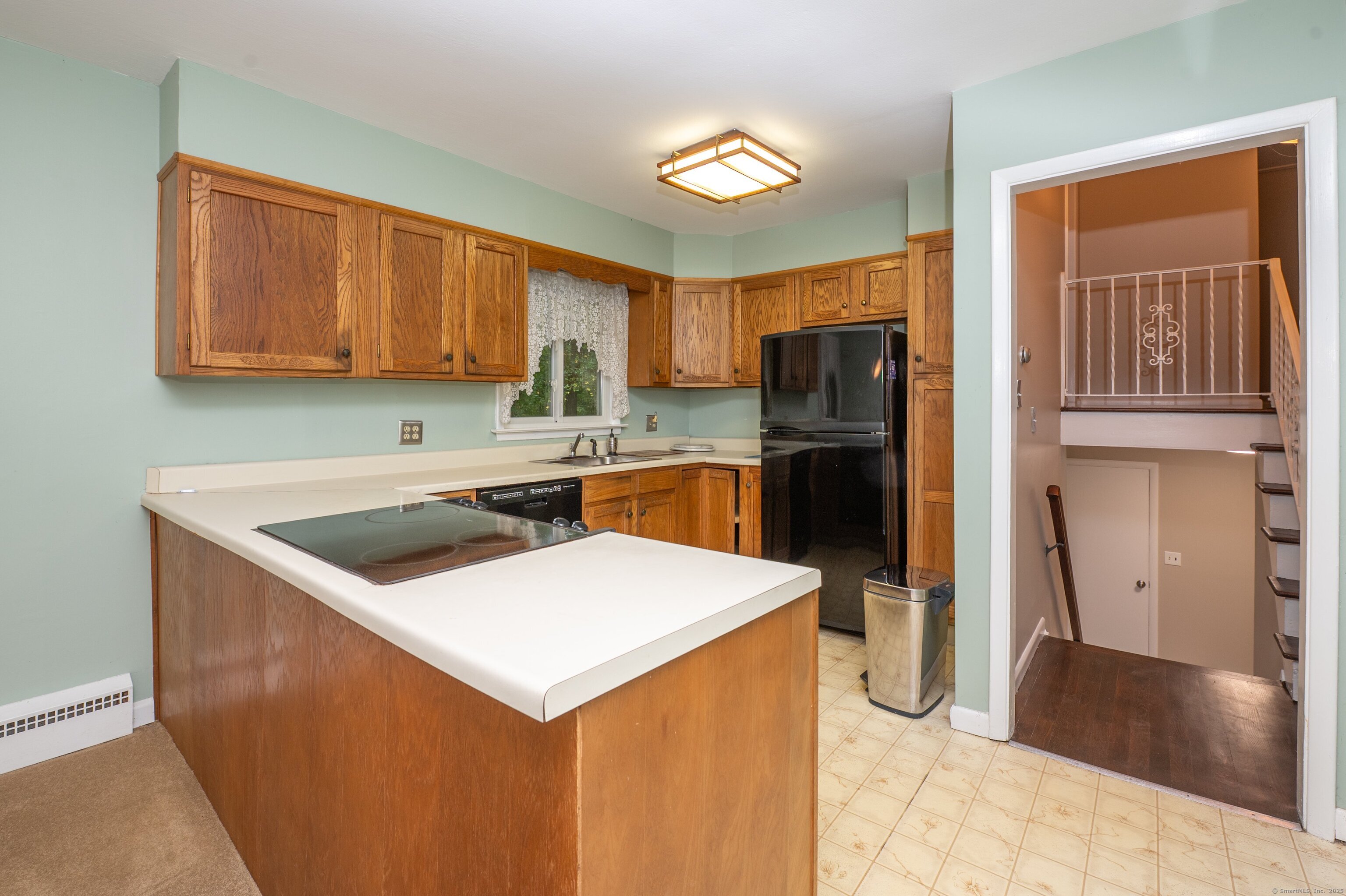 588 Summit Drive Orange, CT 06477 - Photo 13 of 40 a kitchen with a appliances a refrigerator and a stove top oven
