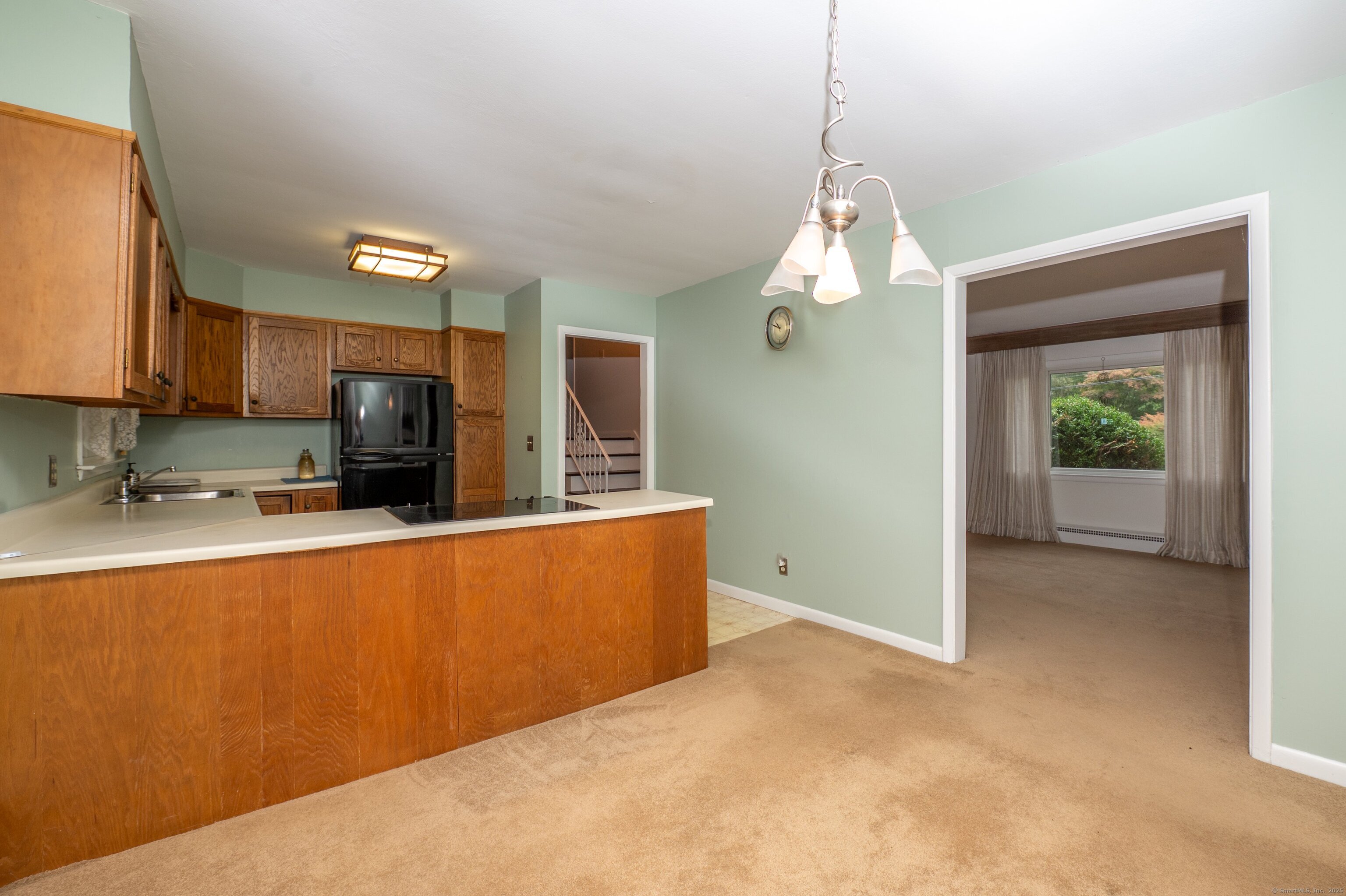 588 Summit Drive Orange, CT 06477 - Photo 15 of 40 a kitchen with stainless steel appliances granite countertop a sink a stove and a refrigerator