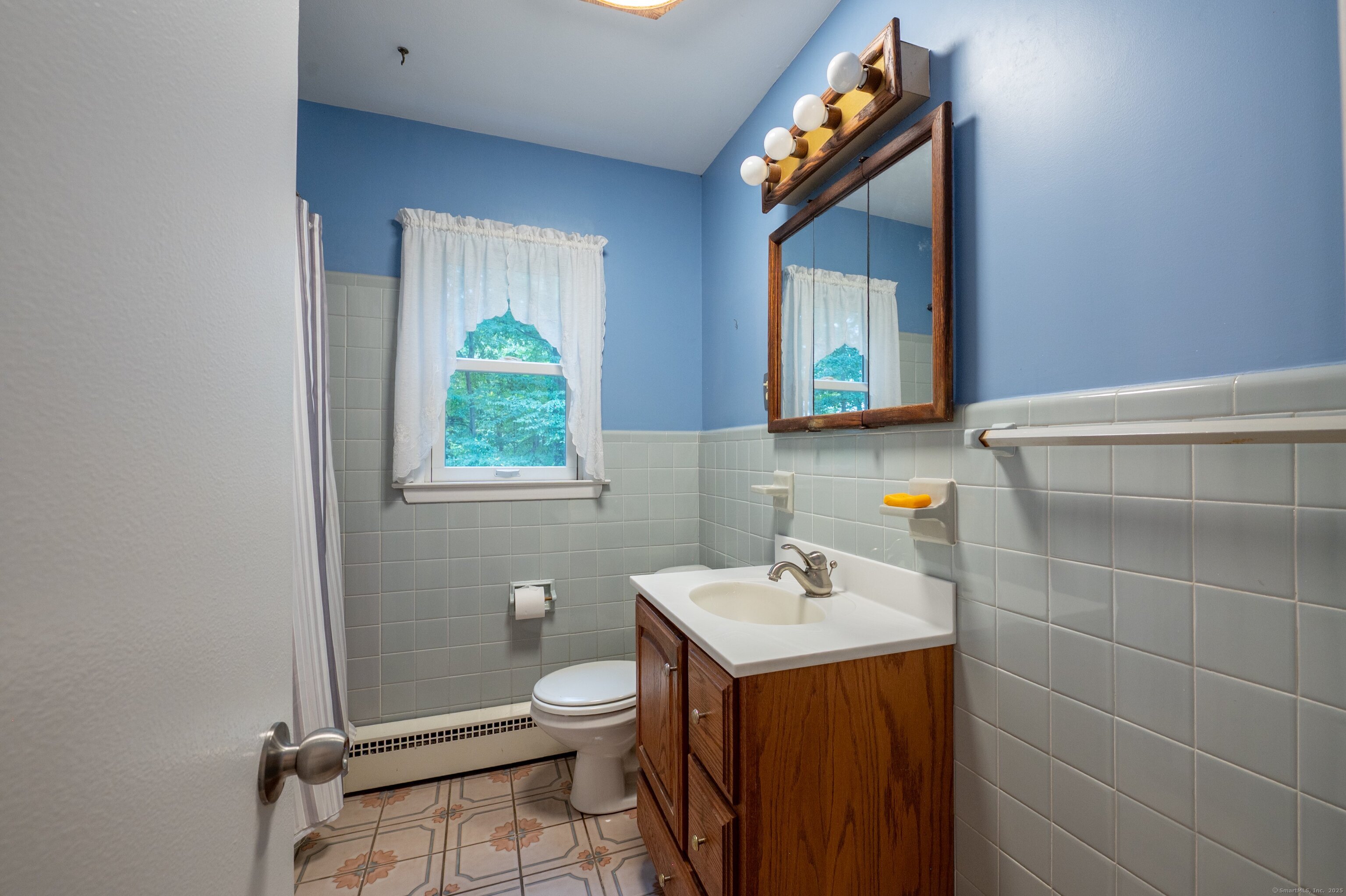 588 Summit Drive Orange, CT 06477 - Photo 20 of 40 a bathroom with a sink a toilet and window