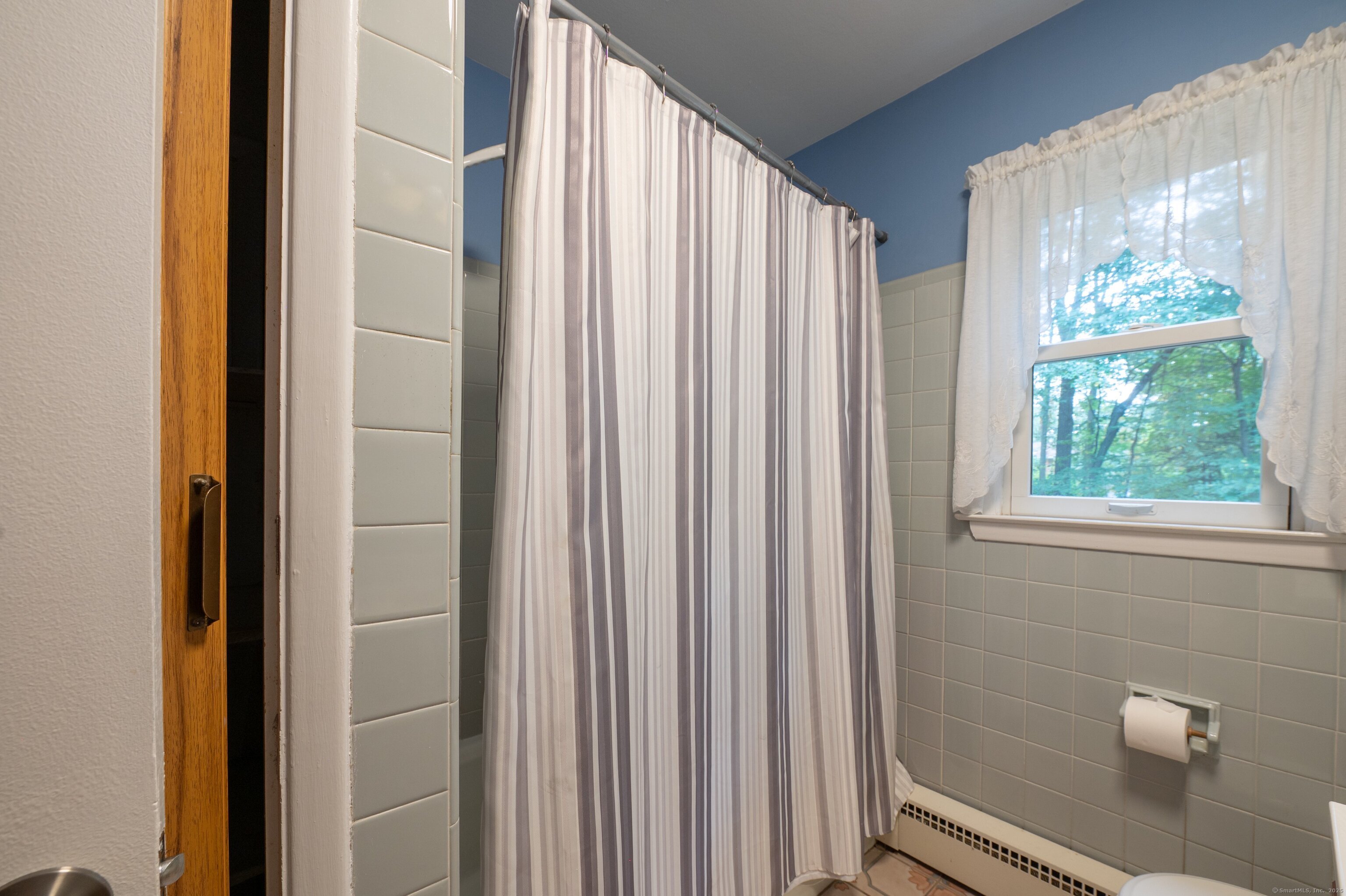 588 Summit Drive Orange, CT 06477 - Photo 21 of 40 a view of a bathroom with a shower and a window