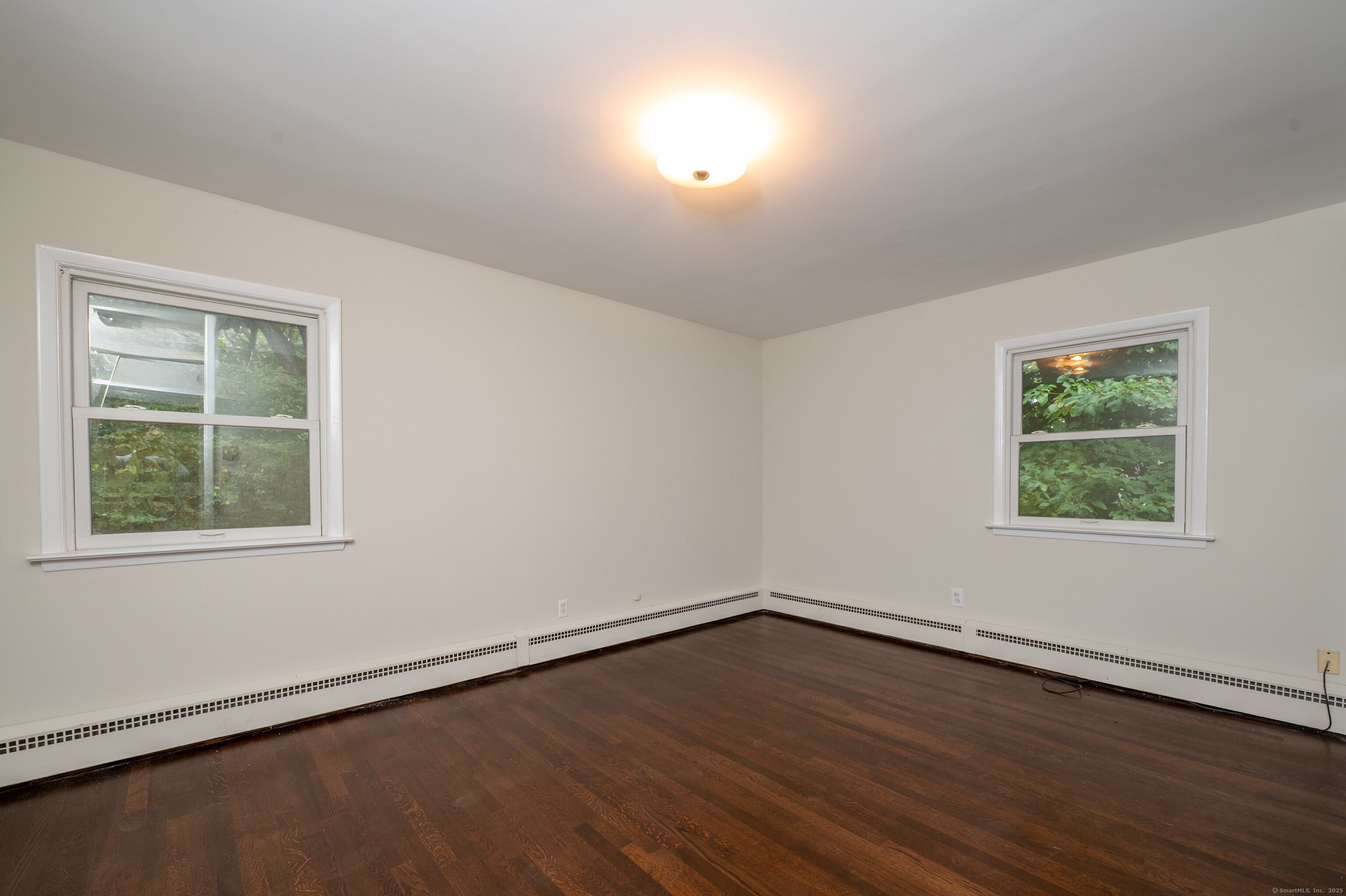 588 Summit Drive Orange, CT 06477 - Photo 22 of 40 an empty room with wooden floor and windows