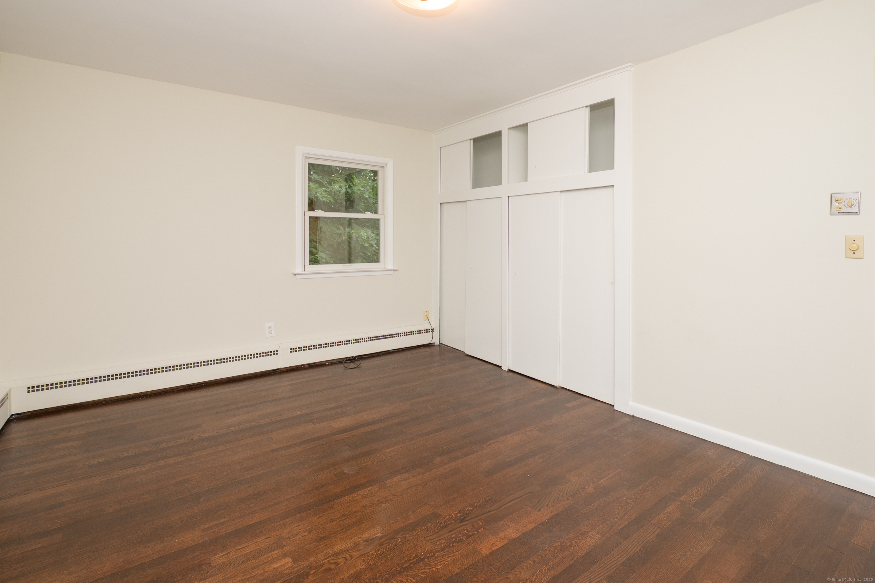 588 Summit Drive Orange, CT 06477 - Photo 23 of 40 an empty room with wooden floor and windows