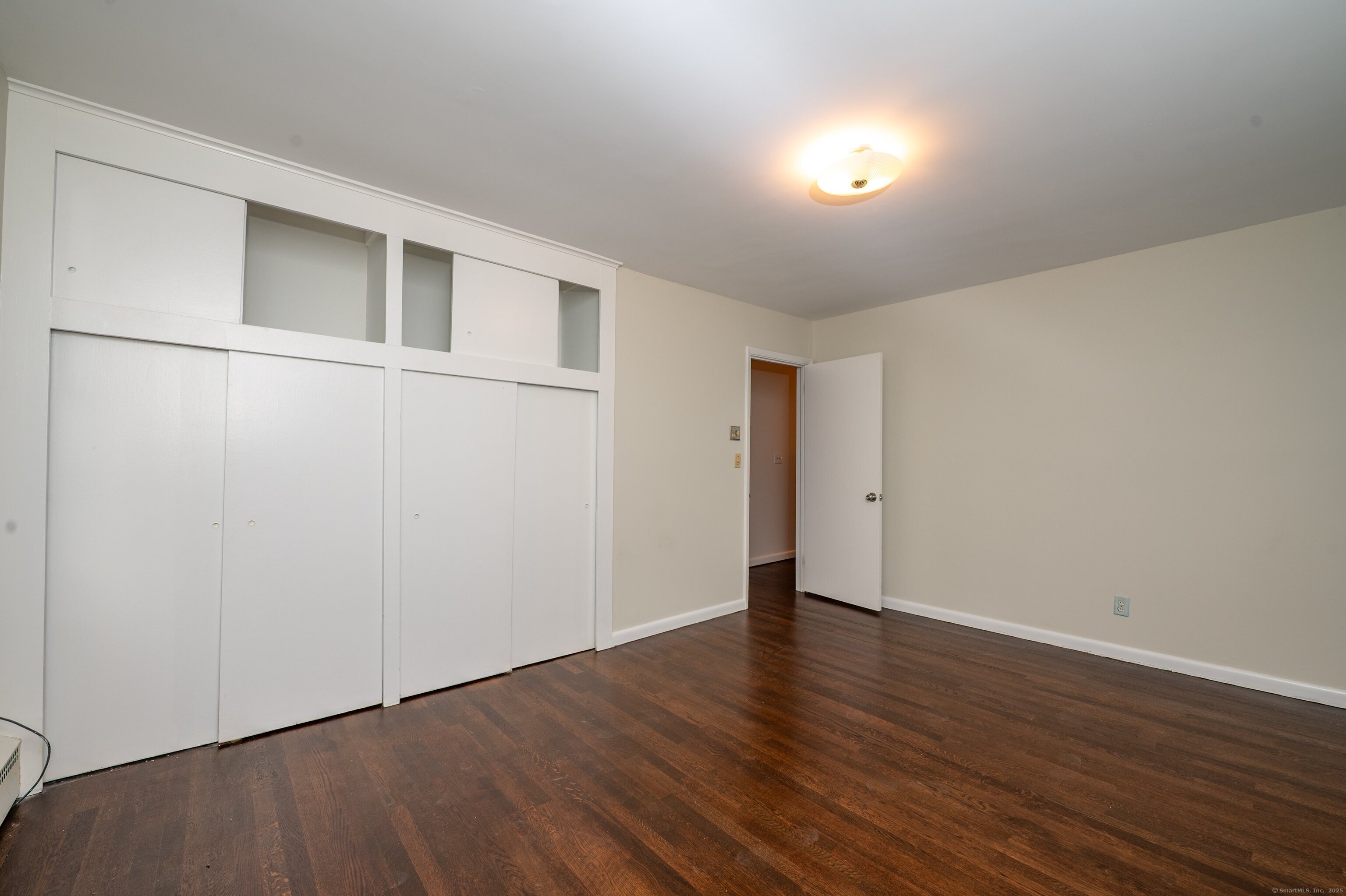 588 Summit Drive Orange, CT 06477 - Photo 24 of 40 a view of an empty room with wooden floor
