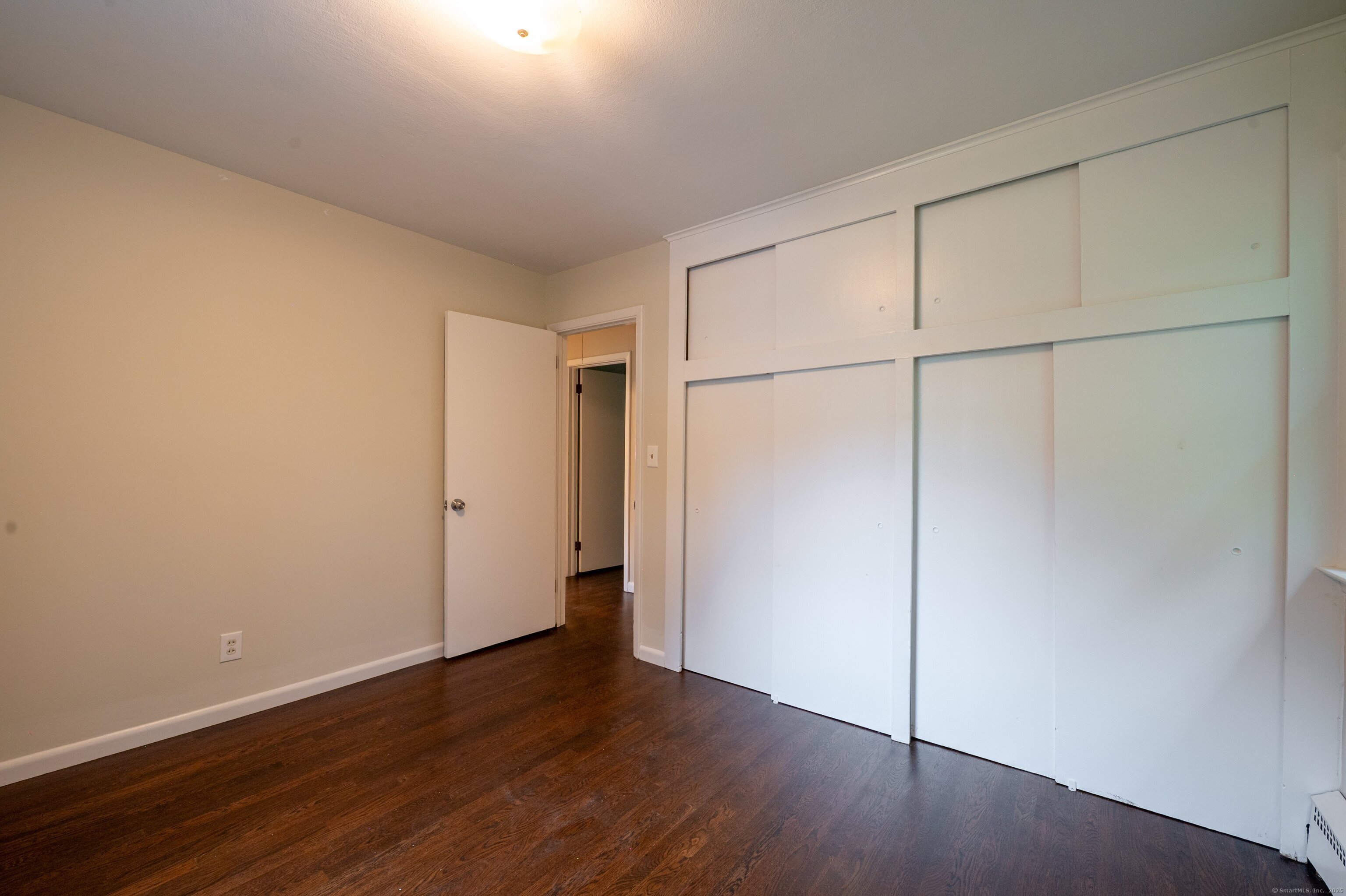 588 Summit Drive Orange, CT 06477 - Photo 27 of 40 an empty room with wooden floor