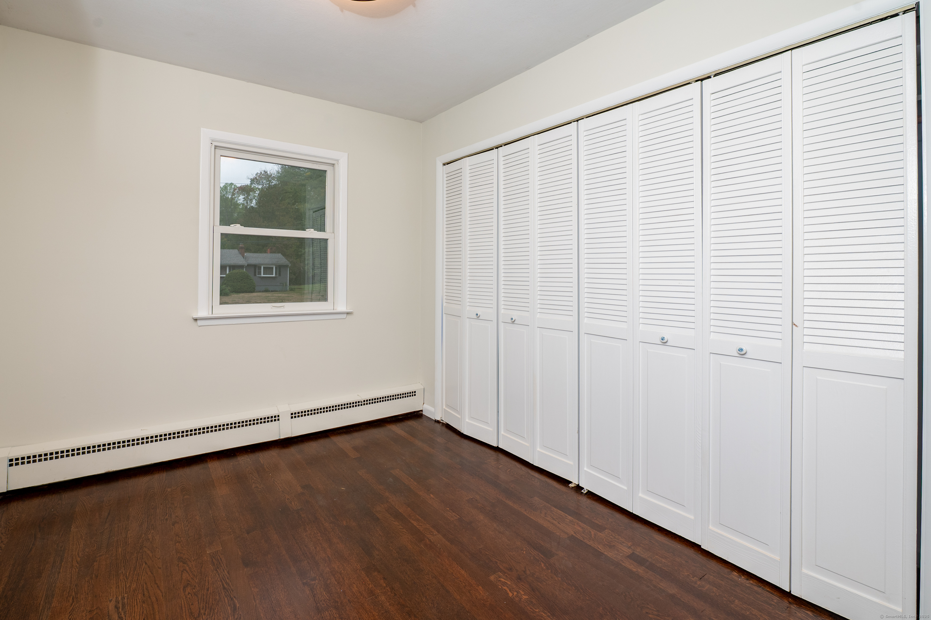 588 Summit Drive Orange, CT 06477 - Photo 28 of 40 an empty room with wooden floor and windows