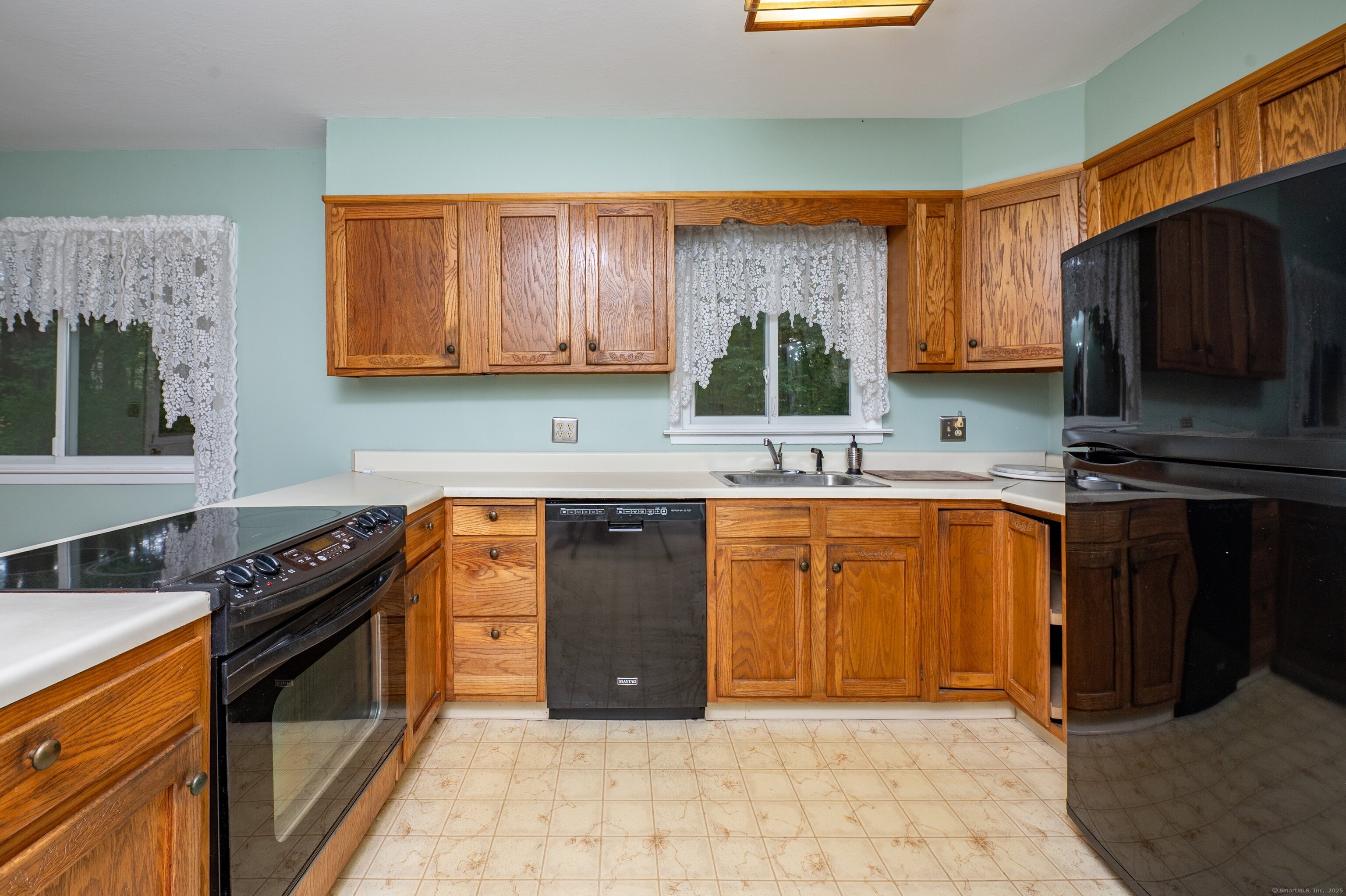588 Summit Drive Orange, CT 06477 - Photo 3 of 40 a kitchen with granite countertop a stove a sink and a microwave