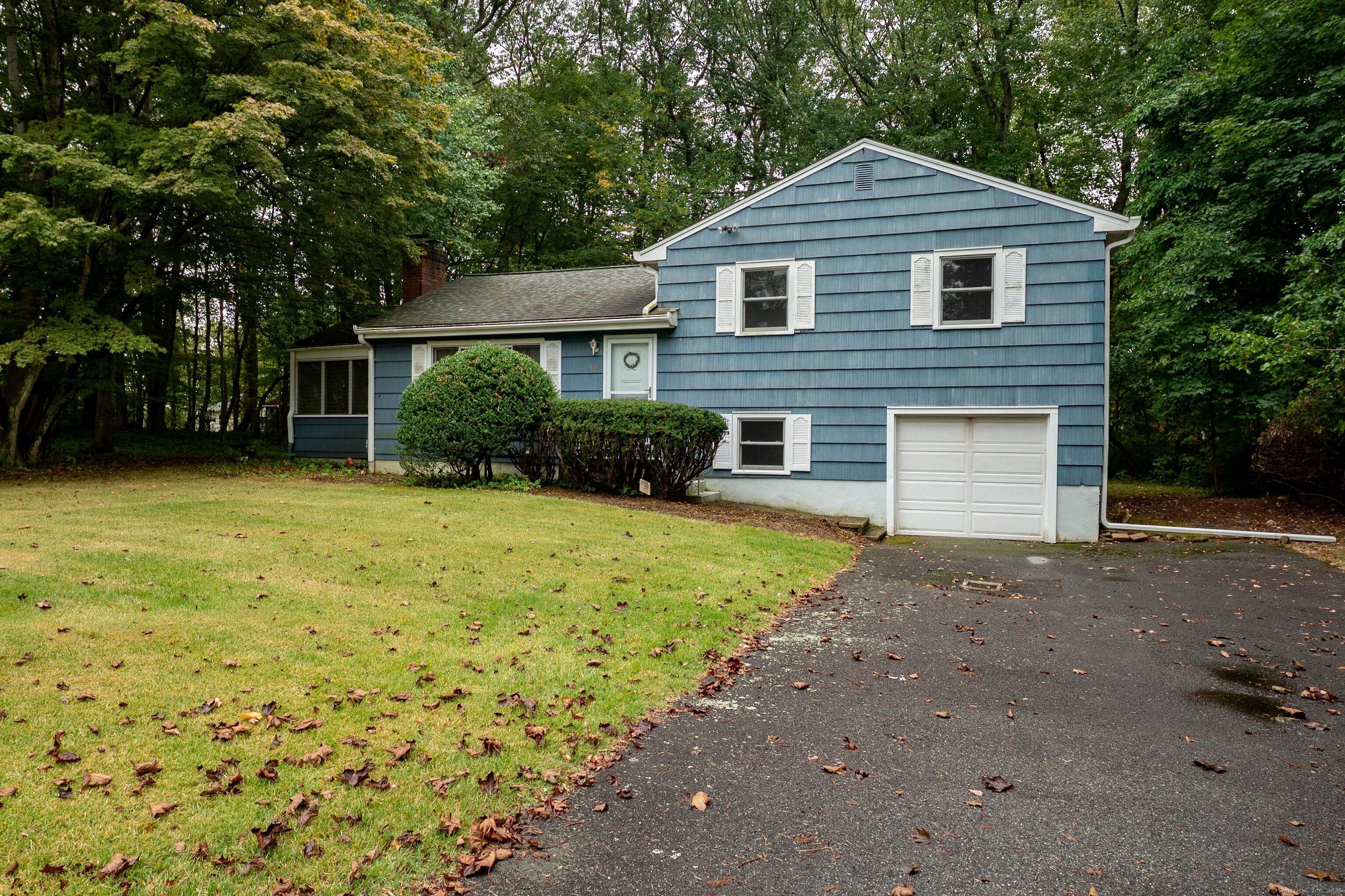 588 Summit Drive Orange, CT 06477 - Photo 37 of 40 a front view of a house with a yard and garage