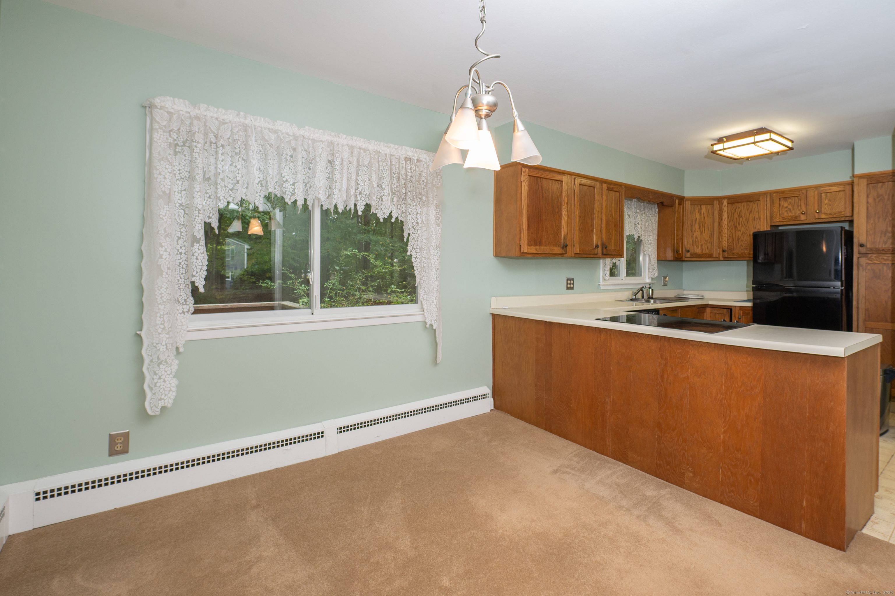 588 Summit Drive Orange, CT 06477 - Photo 4 of 40 a kitchen with stainless steel appliances granite countertop a sink a microwave a refrigerator and a window