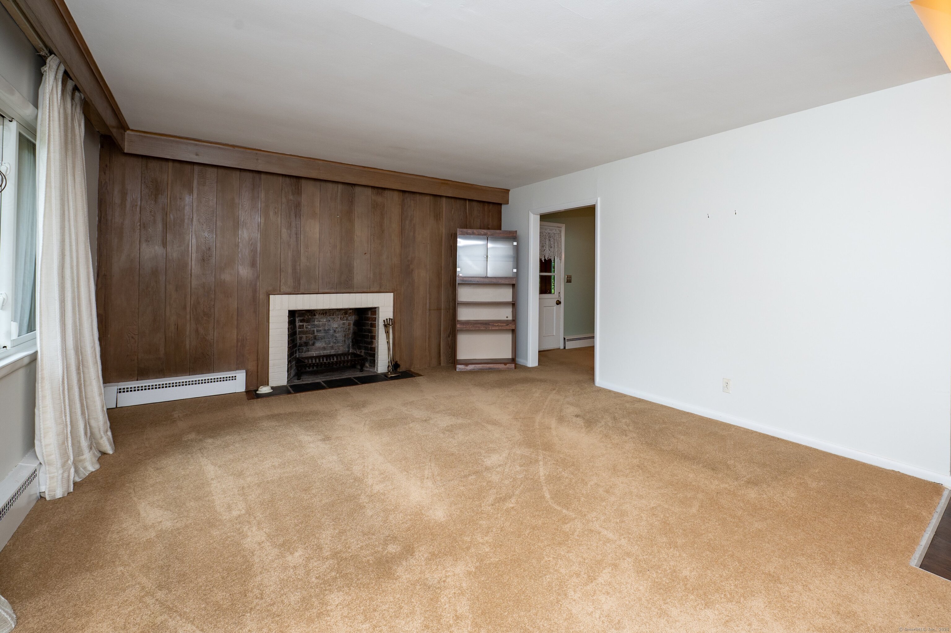 588 Summit Drive Orange, CT 06477 - Photo 9 of 40 an empty room with furniture and a fireplace