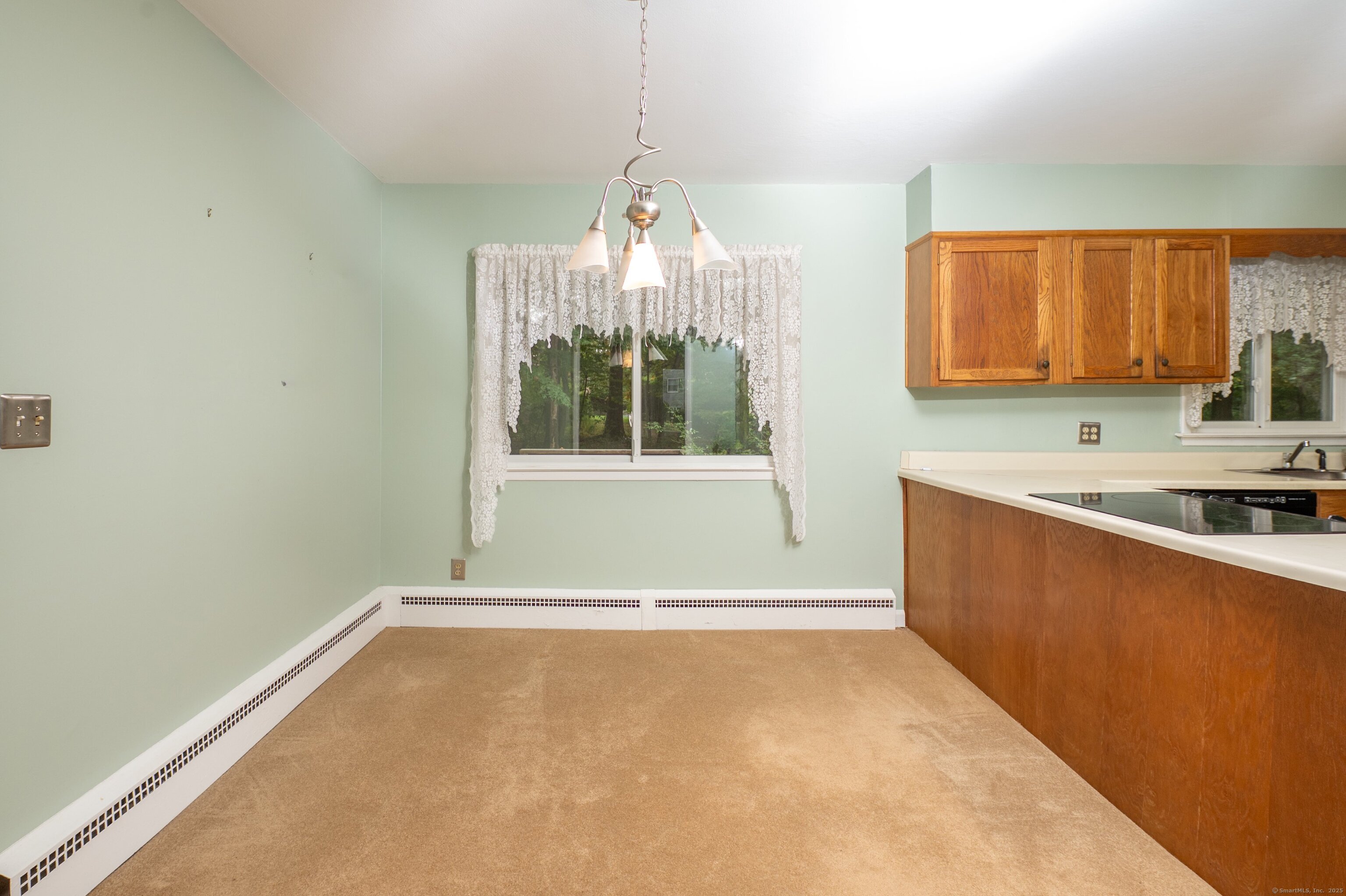588 Summit Drive Orange, CT 06477 - Photo 10 of 40 a view of a kitchen with a sink cabinets and a window