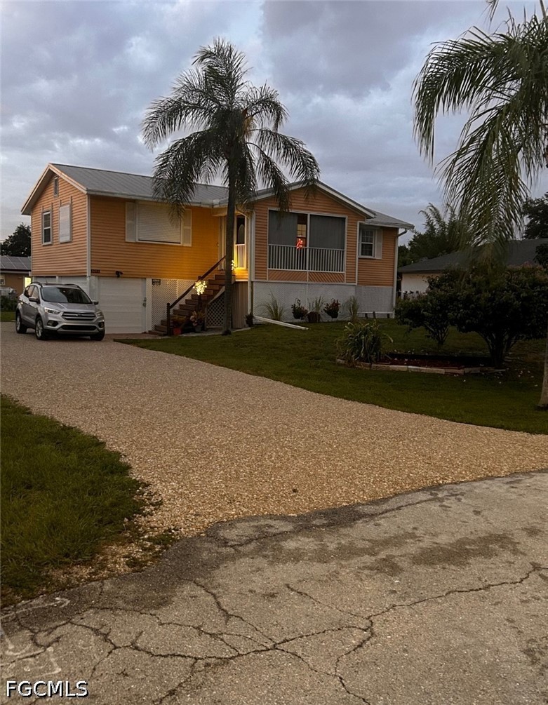 8093 Anhinga Road Fort Myers, FL 33967 - Photo 5 of 49 a front view of a house with garden