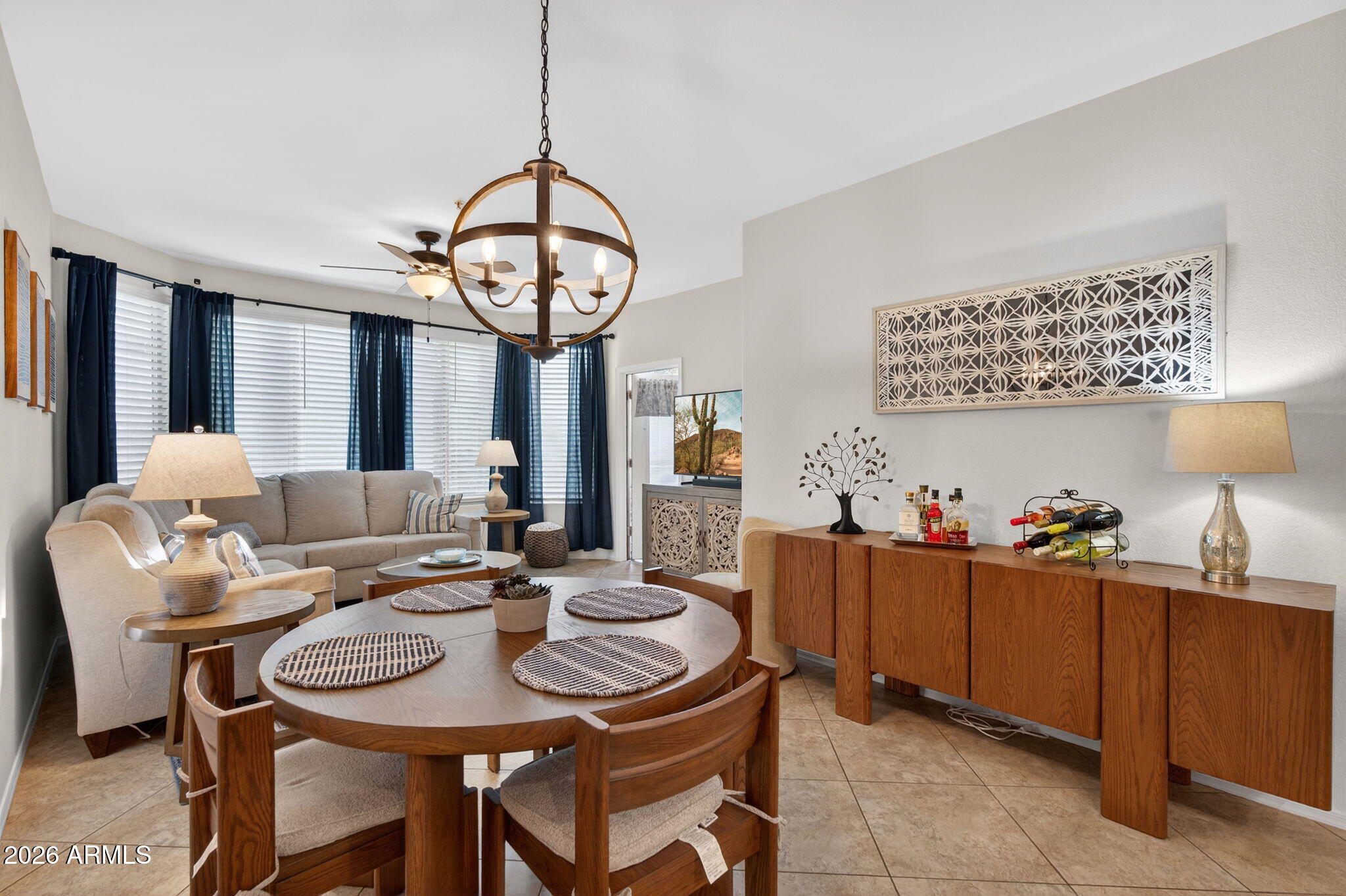 435 West Rio Salado Parkway, Unit 204 Tempe, AZ 85281 - Photo 11 of 60 a view of a dining room and livingroom with furniture a rug a kitchen island and a chandelier
